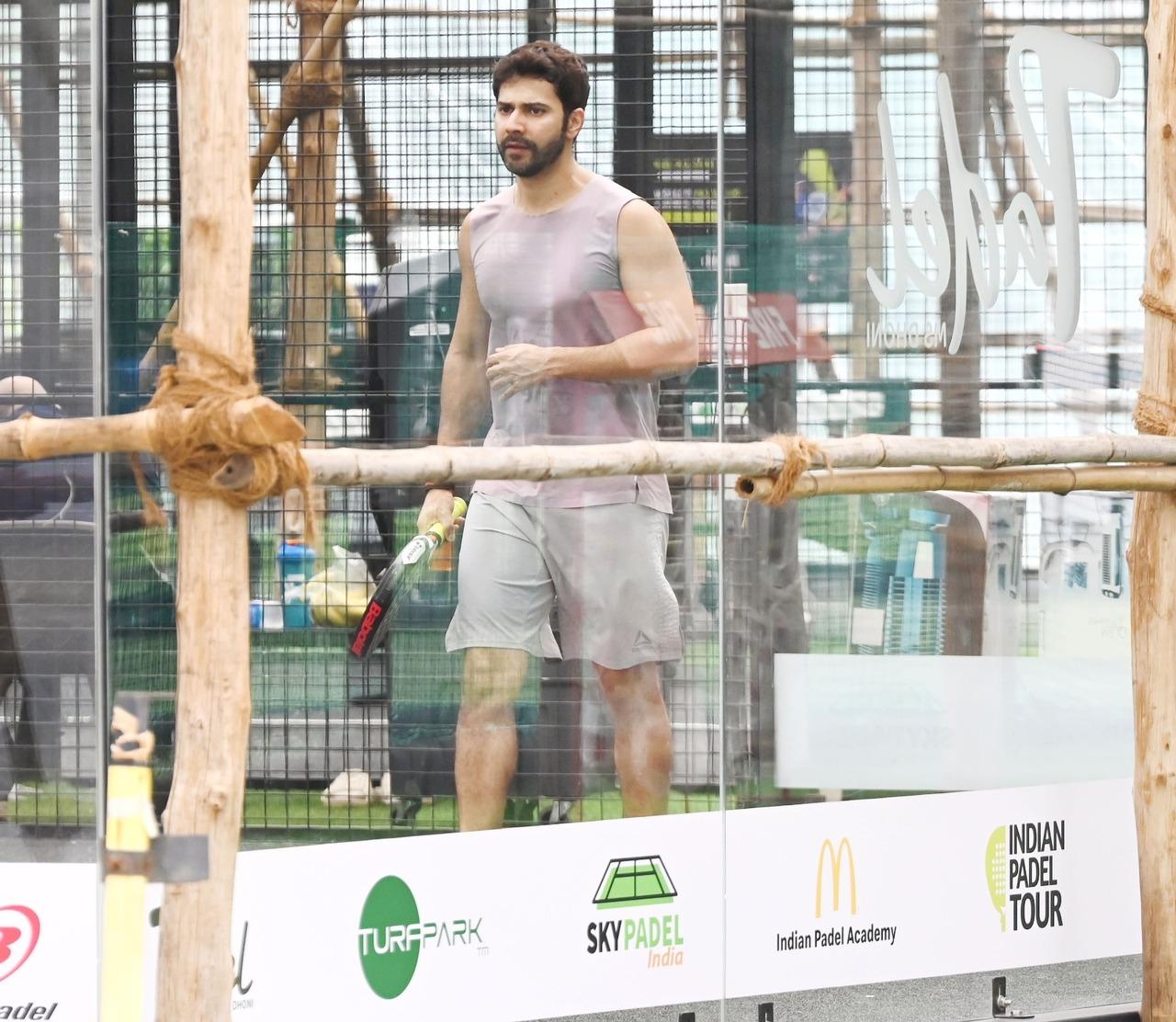 Varun Dhawan was photographed during a padel session in the city. Dressed in a sleeveless grey workout tee, matching shorts, and sports shoes. Varun Dhawan was photographed during a padel session in the city. Dressed in a sleeveless grey workout tee, matching shorts, and sports shoes.